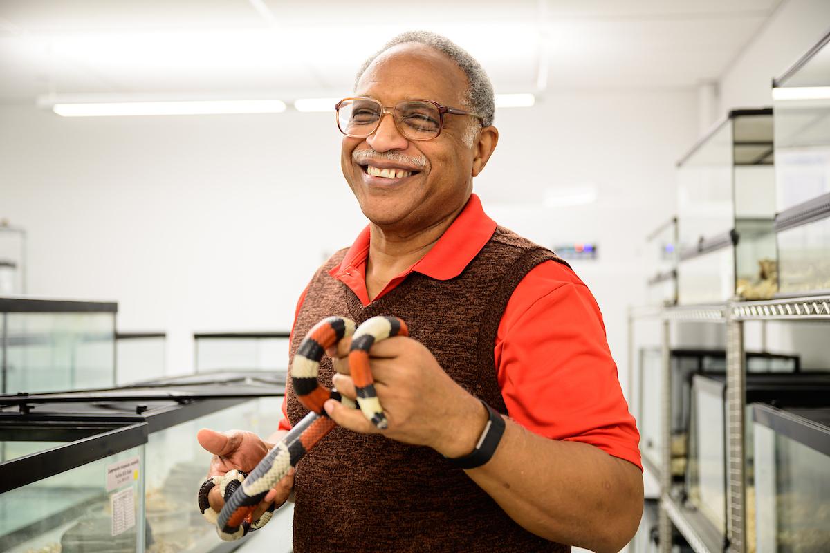 Photo of Dr. Roy Scudder-Davis holding a snake